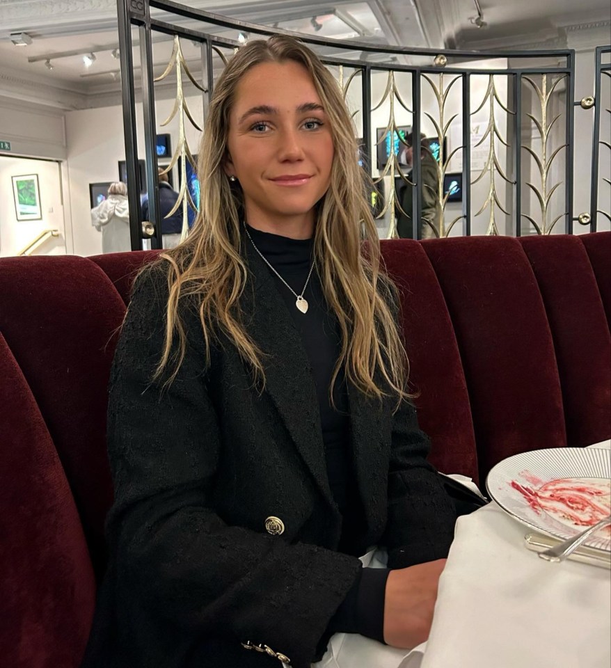 Olivia Peet smiling at a restaurant table.