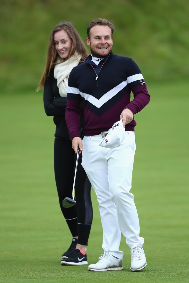 Tyrrell Hatton of England celebrates victory with his girlfriend, Emily Braisher.