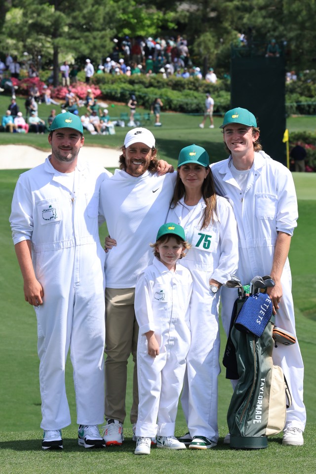 Tommy Fleetwood of England poses with his wife Clare and family during the Par Three Contest at the Masters Tournament.