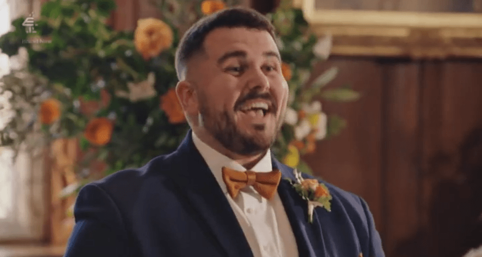 A smiling man in a suit and bow tie.