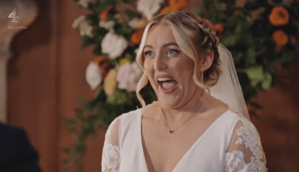 A bride with an open mouth and bulging eyes, looking shocked.