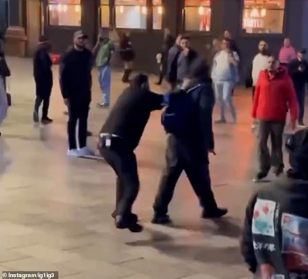 Two of the brave passersby are then seen in a stand-off with him before a security guard ran over and tackled him back down to the ground as he screamed