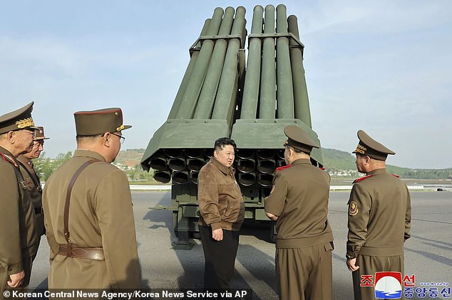 North Korean leader Kim Jong Un, center, supervises a test firing of a new multiple rocket launch system at an undisclosed place in North Korea on May 10, 2024