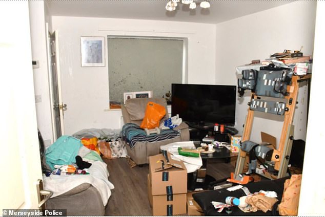 The killer appeared to have been sleeping in the living room of the messy Merseyside home, which was littered with Amazon boxes