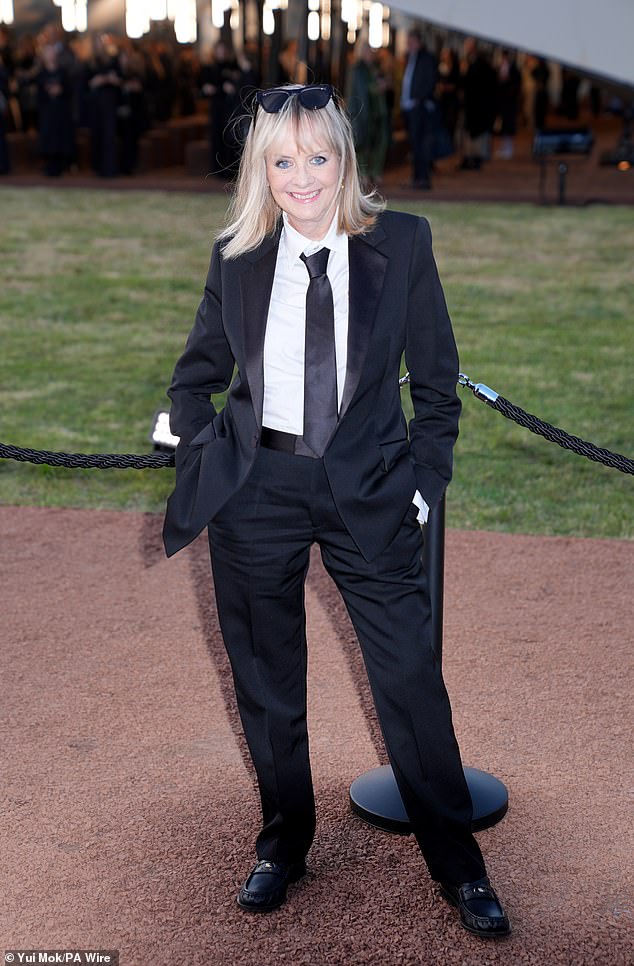 The model, 75, dressed to impress in the smart blazer and matching trousers which she teamed with a crisp white shirt and satin tie