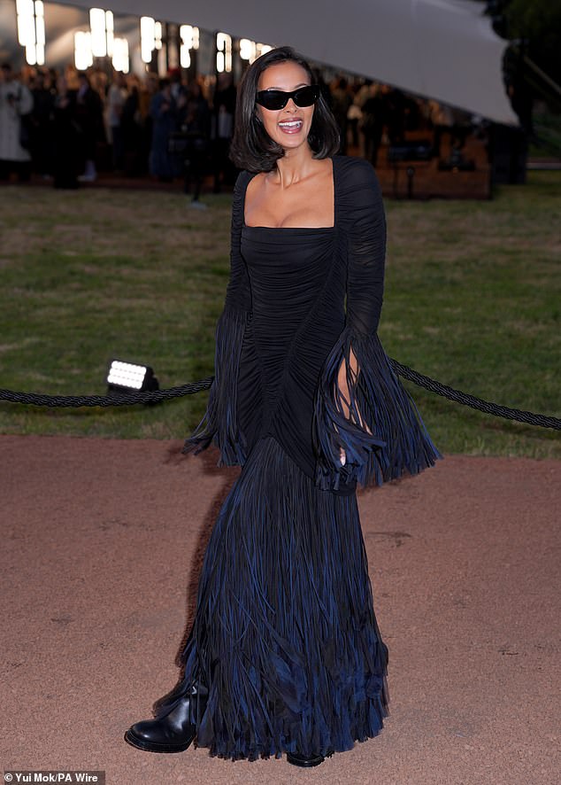 The presenter, 31, ensured all eyes were on her in an arresting black and navy gown that clung to every inch of her toned figure and displayed her ample cleavage