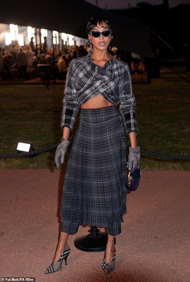The model teamed the cosy jumper with a tartan maxi skirt and added even more inches to her already statuesque frame with grey check stilettos