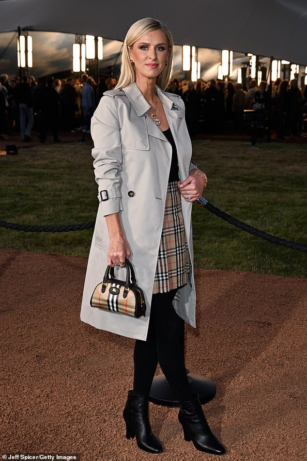 Socialite Nicky Hilton kept things classic and simple in a Burberry check pencil skirt and black boots, under a light grey jacket