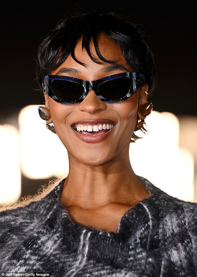 Jourdan elevated her fashion forward look even further with bold accessories, sporting a pair of leather gloves, blue futuristic shades and large silver spike earrings