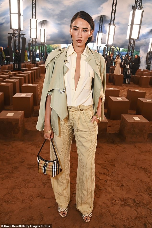 Granddaughter of Dame Vivienne Westwood, Cora Corré put on a daring display in a plunging unbuttoned shirt and fashion forward jeans decorated with stitched seams