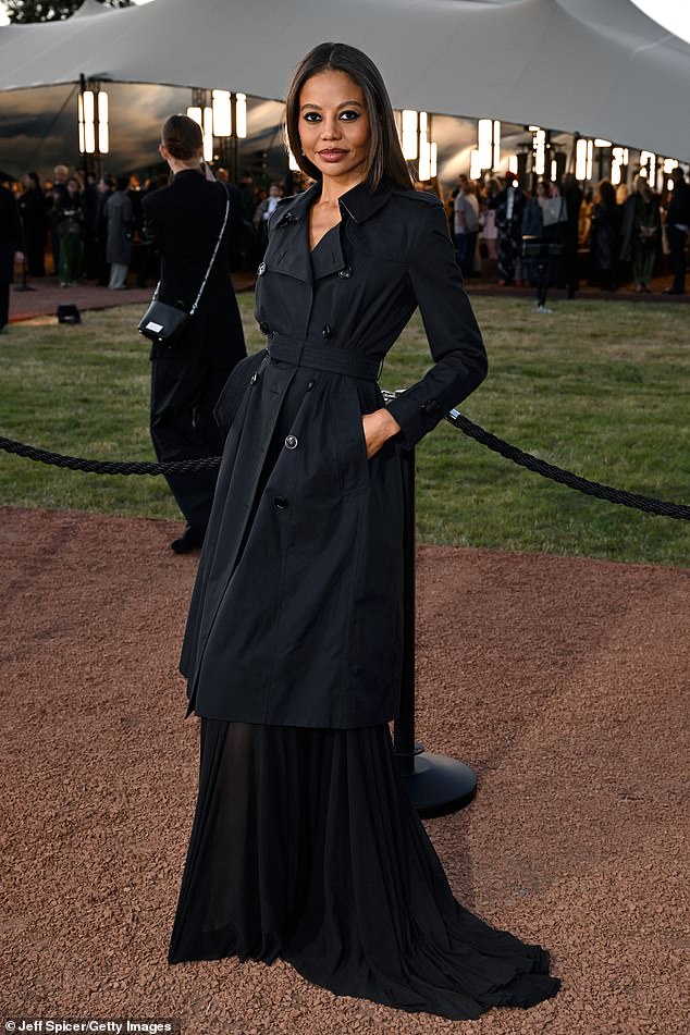 Emma Thynn, Marchioness of Bath, looked elegant in a long black dress with a flowing train underneath a matching trench coat