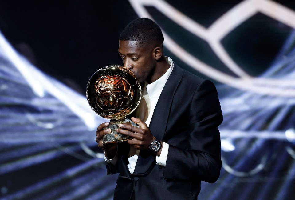 Ousmane Dembele kisses the men's Ballon d'Or award.