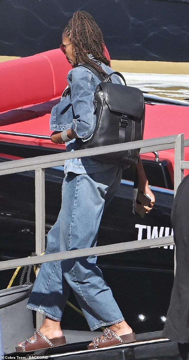 Michelle accessorized with a black backpack and dark shades with her hair in a ponytail