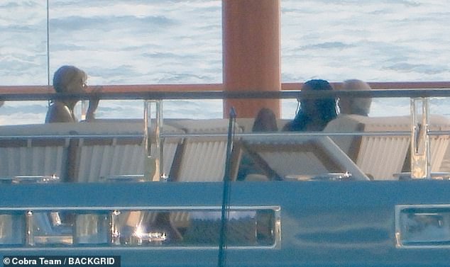 The two were then seen sitting on the boat, called the Seven Seas, chatting happily together, along with a woman who appeared to be his wife, Kate Capshaw