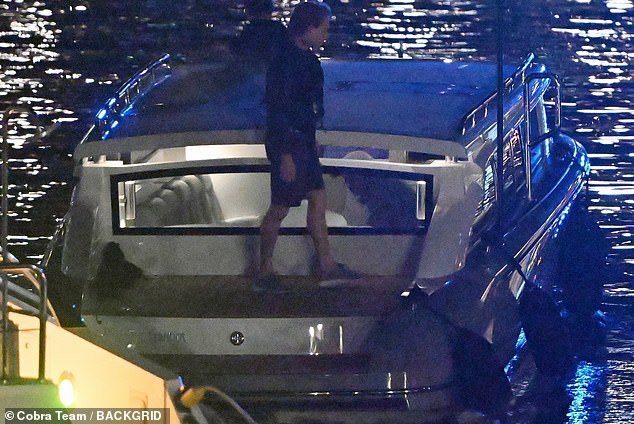 He is alone as a tender takes him to Spielberg's yacht, where his wife is already aboard
