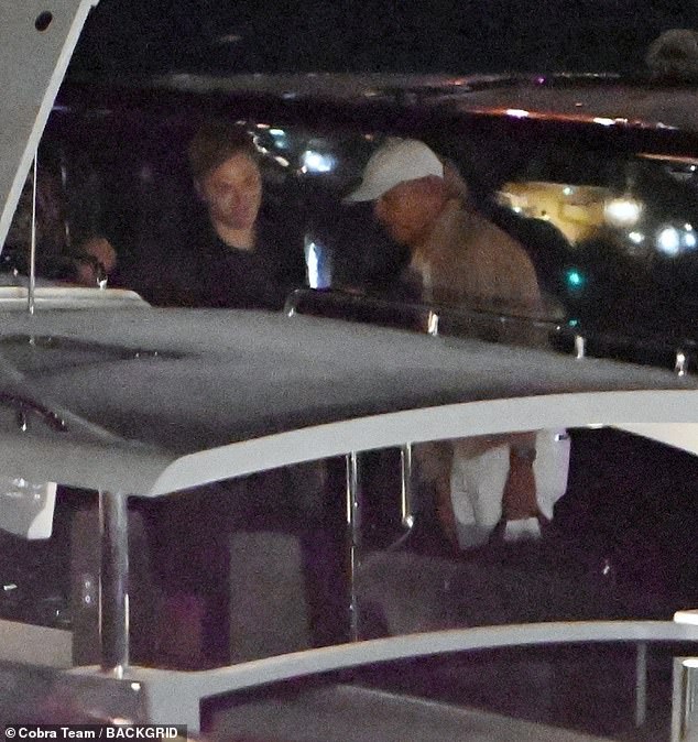 Barack, seen here arriving in Italy, is dressed casually in a brown top and white cap