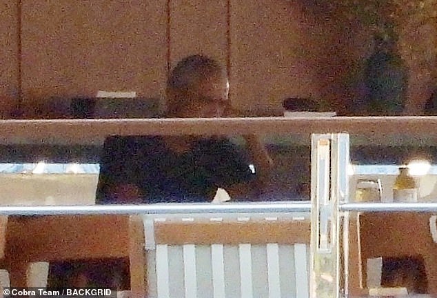 At one point, Barack - who wears a black polo shirt - sits alone staring intently at what appeared to be a tablet or laptop
