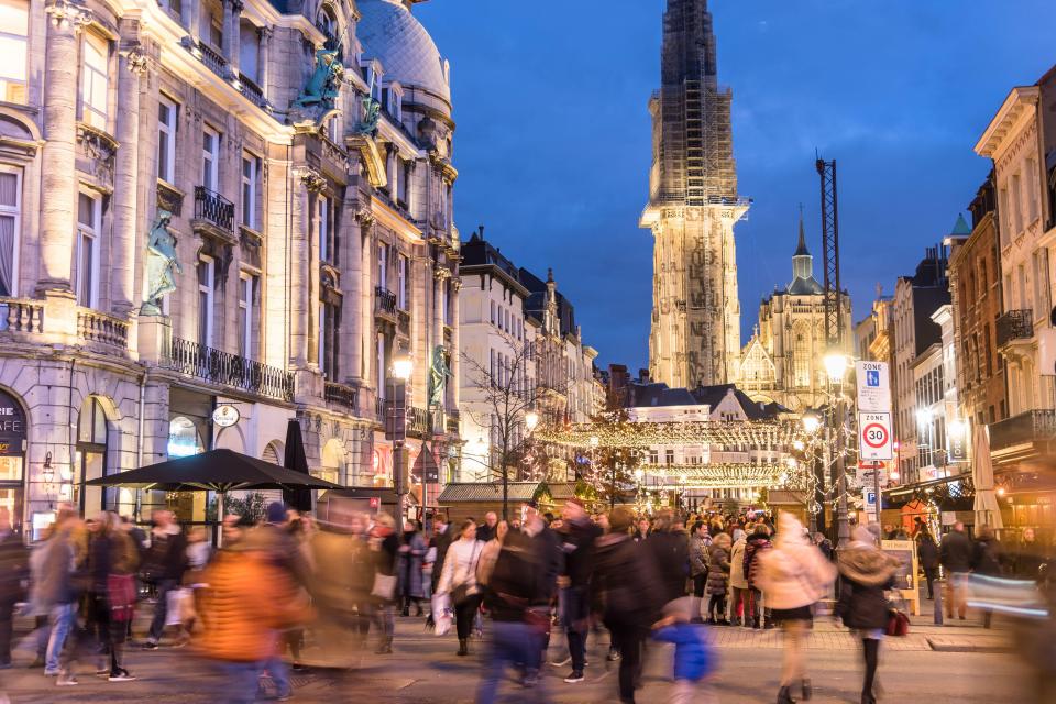 People strolling around the Christmas market in Suikerui street, Antwerp, Belgium.