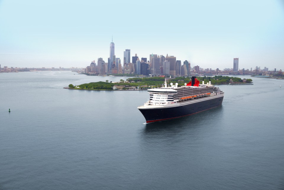 The Queen Mary 2 cruise ship leaving New York, with the city's skyline in the background.