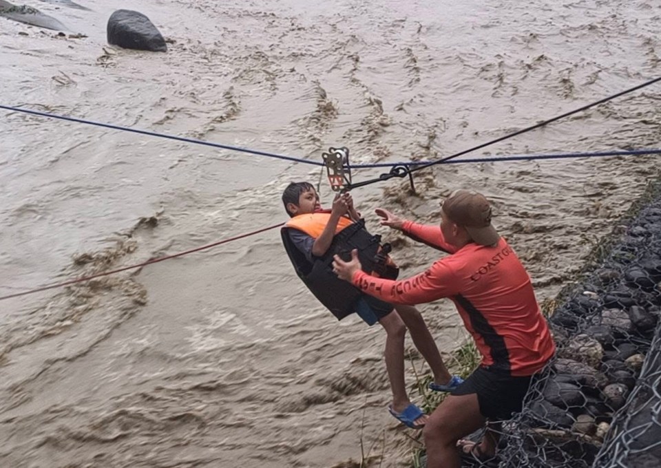 Coastguard personnel conducting a rappel rescue in flood-hit Salcedo, Ilocos Sur province, Philippines.
