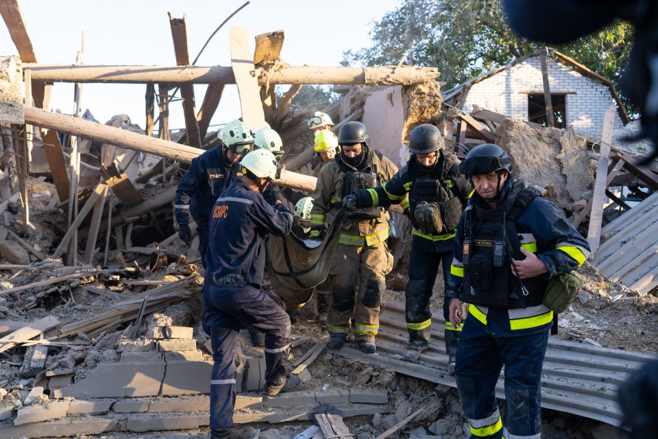 Ukrainian firefighters evacuate a casualty from a destroyed building in Zaporizhzhia.