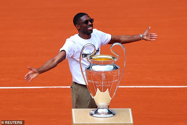 Dembele displays the Champions League trophy at the French Open at Roland Garros