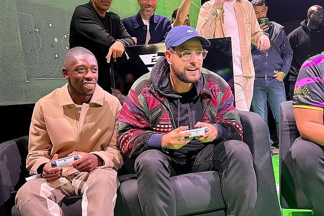 Dembele is pictured on a PlayStation at an event - after criticism he faced earlier in his career