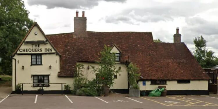 Man wielding crossbow dies after stand-off with police as fire destroys village pub – The Sun