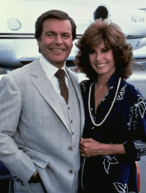 Robert Wagner and Stefanie Powers from the TV show "Hart to Hart" in front of a private jet.