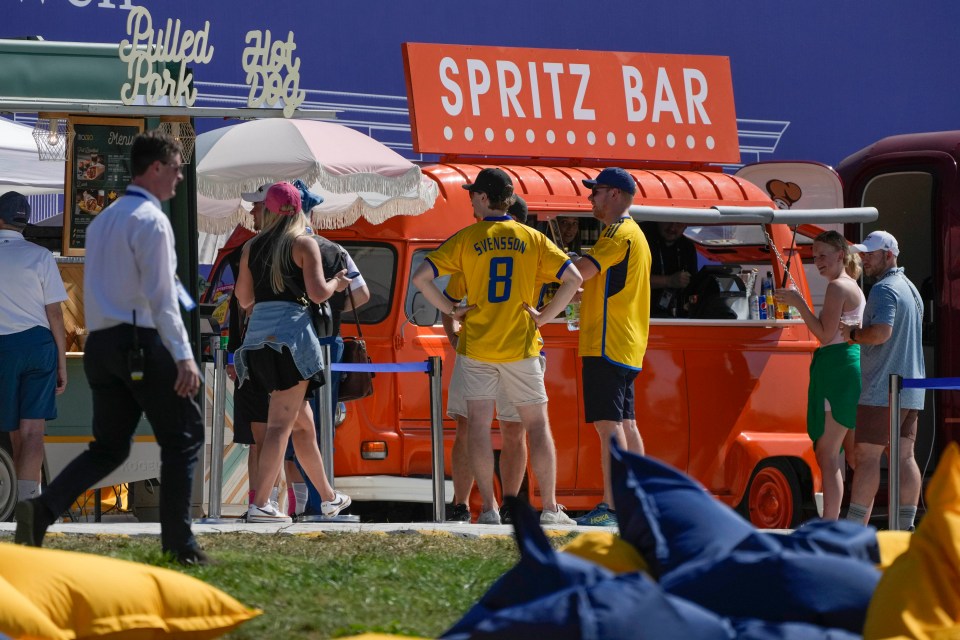 Spectators gather near food trucks at the Marco Simone Golf Club.