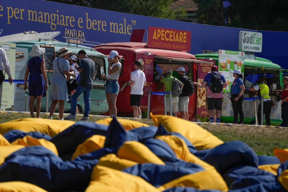 Spectators gather near Italian food trucks at the Marco Simone Golf Club.