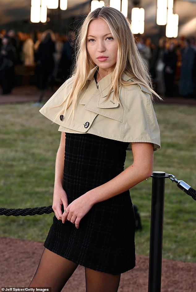 Lila - Hack's only child with notably absent catwalk legend Kate Moss - inevitably commanded attention in a distinctive cropped trench and plaid dress