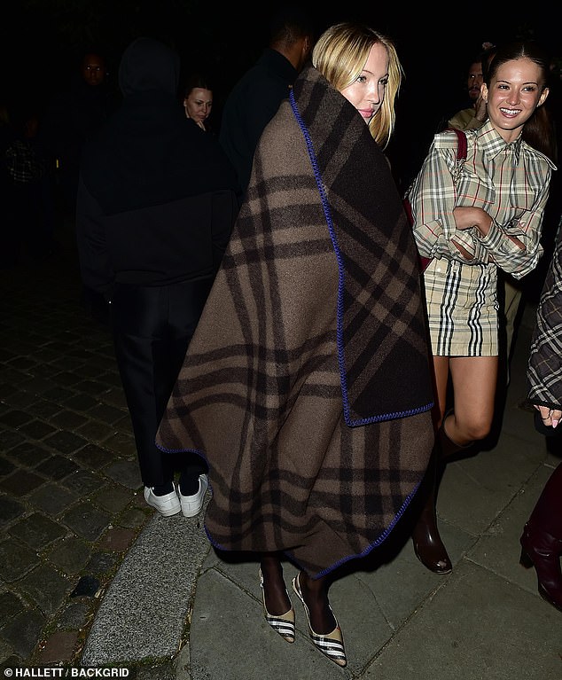On a chilly night in the English capital, she draped herself in a heavy wool blanket from the heritage brand as she mingled with a group of friends