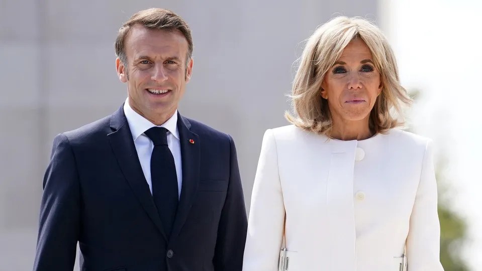 Emmanuel Macron and Brigitte Macron smiling.