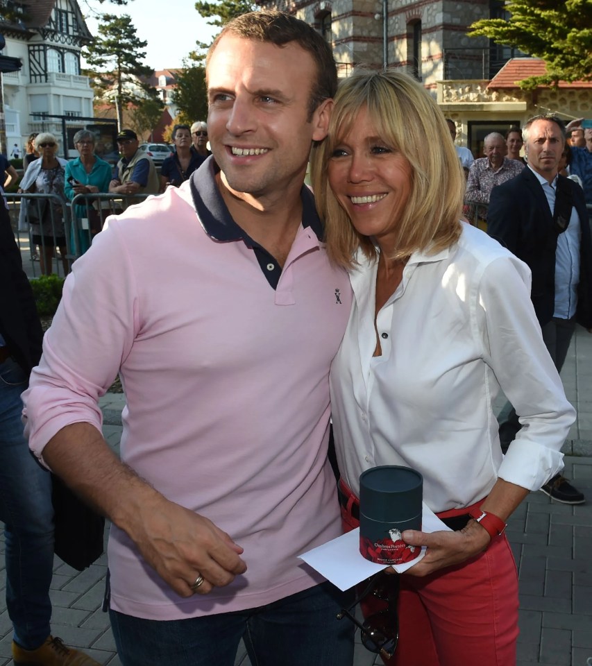 French President Emmanuel Macron and his wife Brigitte Macron posing for photographers.