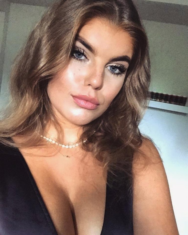 Theresa Sommer in a black top and pearl necklace.