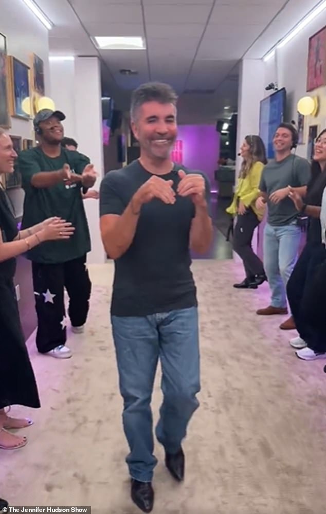 As crew members lined the corridor and sang about Simon in the tune of The Greatest Showman, the America's Got Talent judge clapped along