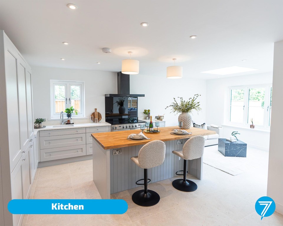 Modern kitchen with island and seating.