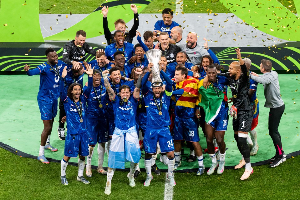 Reece James of Chelsea lifts the UEFA Conference League trophy with his teammates.