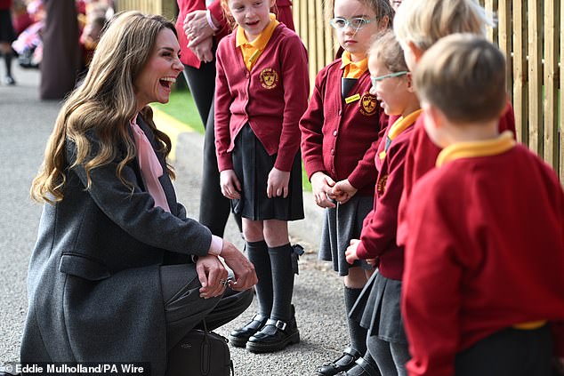 Beaming Kate was full of laughter as she chatted to excited children at the school in Southport
