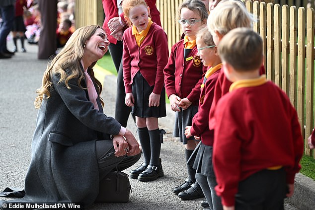 The Princess of Wales shares a smile with a pupil at Farnborough Road Infant and Junior School