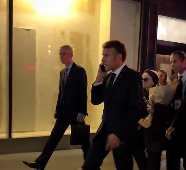 The French president was then seen walking down the street with his bodyguards after roads reopened, but only for pedestrians