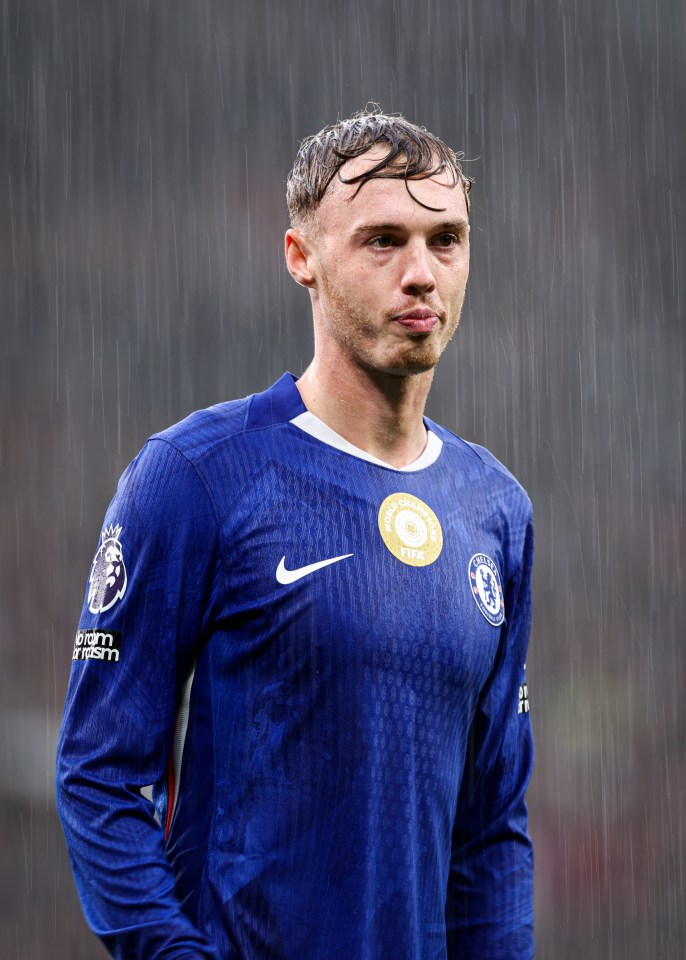 Chelsea's Cole Palmer looking on in the pouring rain.