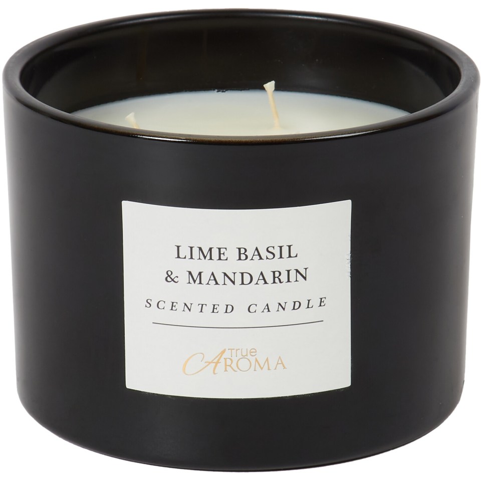 Black ceramic candle with a white label reading "LIME BASIL & MANDARIN SCENTED CANDLE" and "True Aroma".