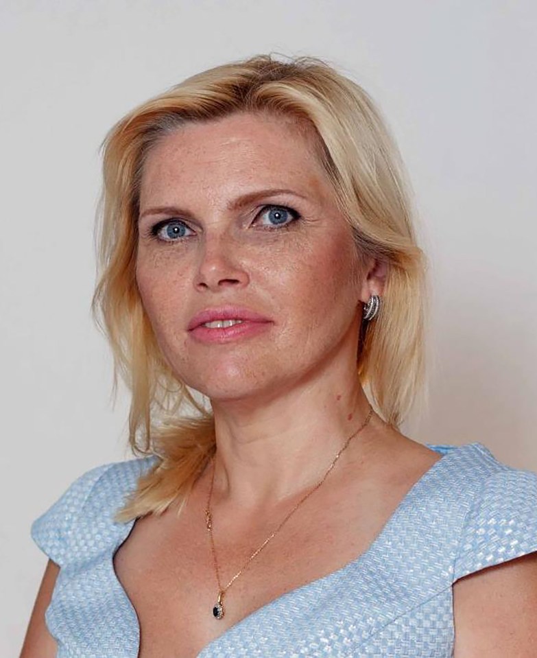 Angela (Anzhela) Nikolenko, with blonde hair, blue eyes, and wearing a light blue dress.