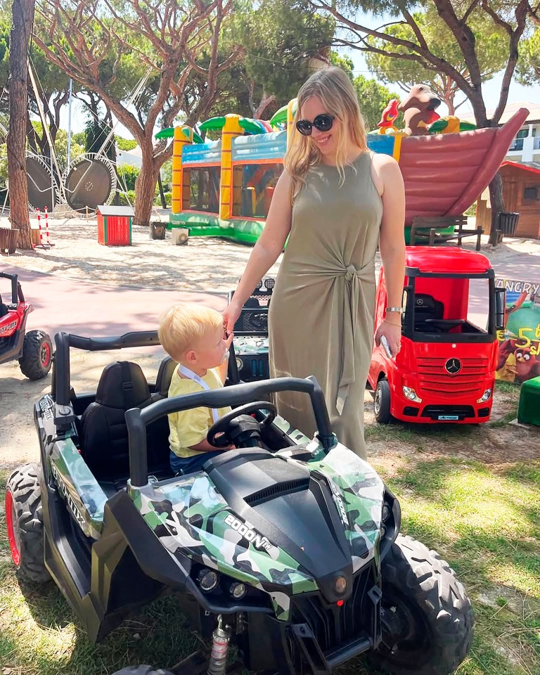 Anastasiia Chikina with her son Oliver Pugh in a toy car in Marbella, Spain.
