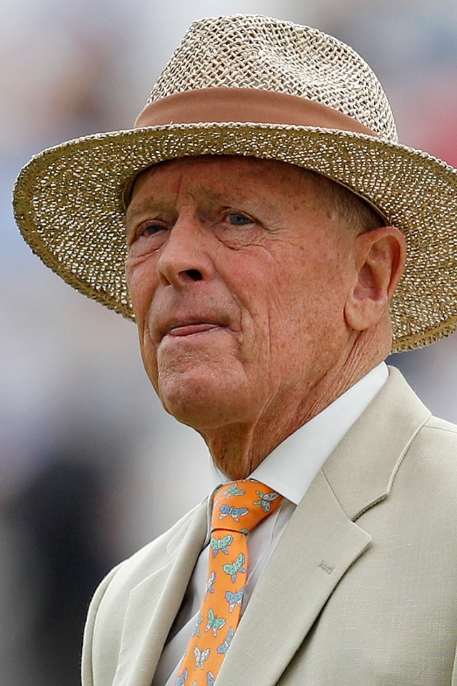 Geoffrey Boycott, former England cricketer and commentator, wearing a straw hat and an orange tie with butterfly patterns.