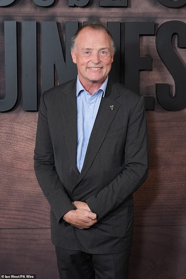 Edward, 56, 4th Earl of Iveagh and son of Benjamin Guinness appeared in cheerful spirits, looking sharp in a grey suit and blue shirt