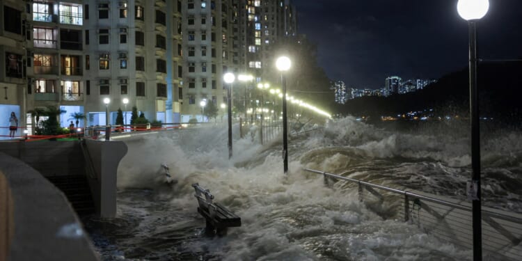 World’s BIGGEST super typhoon this year slams into Hong Kong & washes pair out to sea while lake bursts in Taiwan