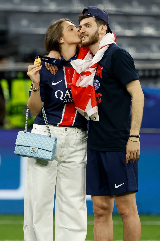 Khvicha Kvaratskhelia of PSG and his wife Nitsa Tavadze celebrating a UEFA Champions League win.